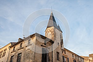 Facade of a medieval building with an old stone tower in the older town vieille ville of Libourne