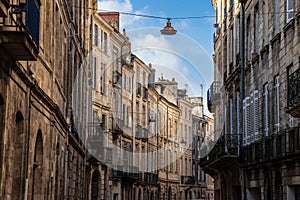 Facade of medieval buildings in a street in the city center of Bordeaux, France.
