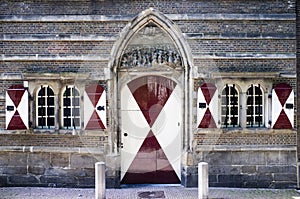 Facade of a medieval house with white and red shutters in the center of Leiden, Holland