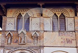 Facade of medieval palazzo, decorated with frescoes in Florence