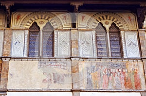 Facade of medieval palazzo, decorated with frescoes in Florence
