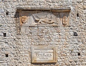 Facade of medieval Tower Revelin with relief comemorative plaque. Korcula, Croatia