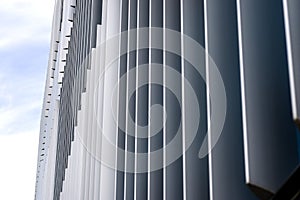 The facade of a modern building with an innovative facade made of automatic, movable blinds.