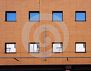 Facade of modern building. Reflection of blue sky in windows
