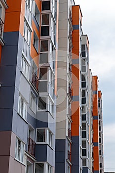 The facade of a modern building in which people live in apartments in the city center. modern new construction