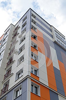 The facade of a modern building in which people live in apartments in the city center. modern new construction