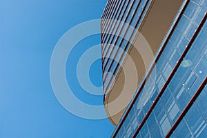 Facade of a modern corporate building with blue sky in the background