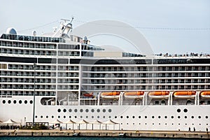 The facade of a modern cruise ship with lifeboats