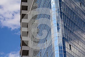 Facade of modern glass blue office and sky