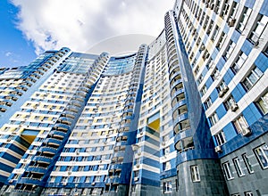 The facade of a modern multi-storey high-rise building with windows in Moscow