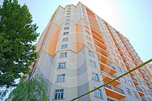 Facade of modern multi-storey new residential orange building near BAku . New apartment house . Storey houses modern . High rise