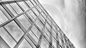 Facade of a modern office building with glazing, perspective, fragment, monochrome