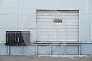 Facade of modern warehouse with gate and lift