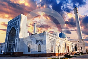 facade of modern white marble Islamic Masjid Minor Mosque in Tashkent in Uzbekistan on background of sunset sky in