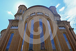 Facade of Monumental cathedral in Modena, Italy, Tempio monumentale ai Caduti di Guerra across the blue sky from beneath photo