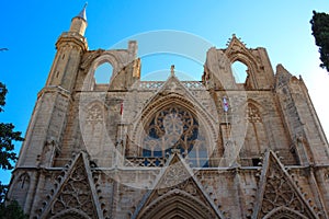 The facade of the Mosque Lala Mustafa Pasha mosque former St. Nicholas Cathedral on the background of blue sky. Famagusta.