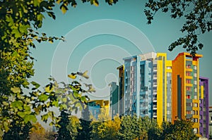 The facade of a multi-storey multi-colored building on the backg