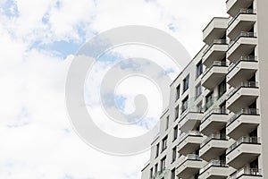 Facade of new colorful modern residential building side view on sunny day closeup with sky background