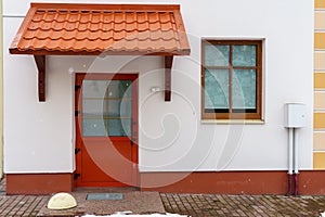 The facade of a new office building with red plastic windows and doors. The building is after a modern renovation. The concept of