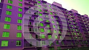 Facade of new residential building violet color. House Share. Real estate. Mortgage Interest Rates concept. Construction industry.
