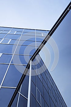 Facade of office building and reflections of sky