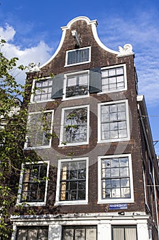 Facade of an old 17th century house along the Prinsengracht canal in Amsterdam - Holland