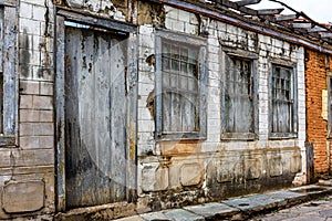 Facade of old abandoned house ruined by time in the city of Diamantina in Minas Gerais