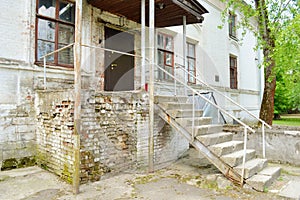 Facade of an old brick building with a staircase