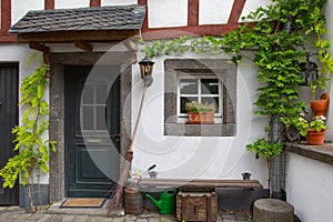 Facade of an old building decorated with plants and flowers under the sunlight in Germany