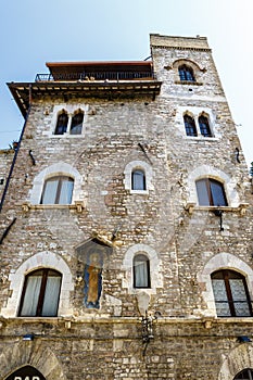 Facade of an old building in the historic center of Assisi, Umbria, Italy