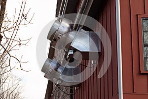 Facade of an old building with ventilation exhaust pipes