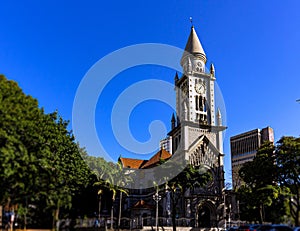 Facade of an old church next to buildings.