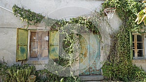 The facade of an old country house with an old basketball hoop on the wall