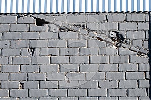 Facade of an old factory partly covered with corrugated iron