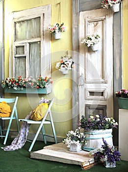 Facade of the old house in bright colors decorated with flowers vintage