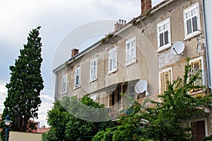 Facade of an old house in the old town of Rovinj, Croatia, with some vegetation
