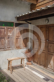 Facade of an old house with vintage suitcases near the doo