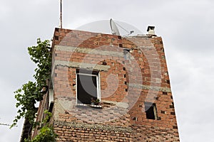 Facade of old incomplete brick building