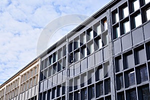Facade of an old industrial office building with a predominance of old cement and old structural elements.