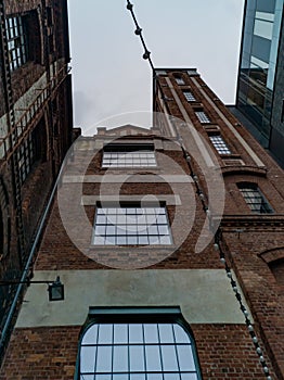 Facade of old red brick building with small tower