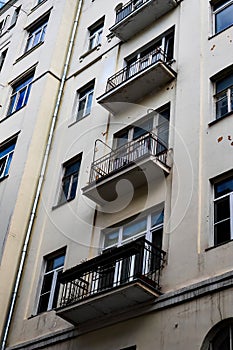 facade of old residential building with balconys and drainpipe photo