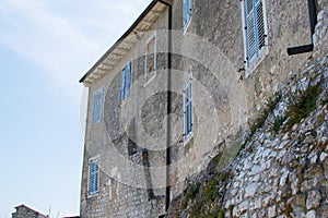 Facade of an old ruined house on a stone wall in the old town of Porec Parenzo, in the Istrian Peninsula, Croatia