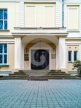 Facade of old school building with ornaments and reliefs