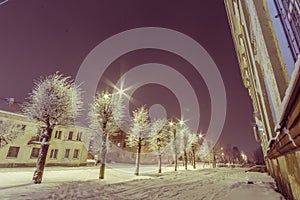 Facade of old school building. Winter landscape. Night.