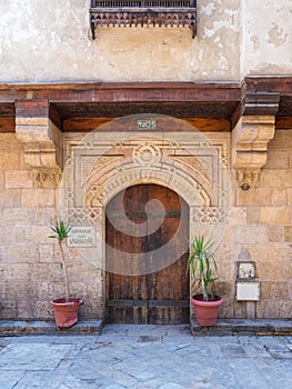 Stone bricks wall with arched wooden door of house of Moustafa Gaafar Al Selehdar, Cairo, Egypt