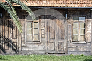 Facade of an old wooden house. Background of the wooden wall of the house