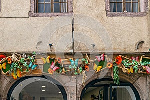 Facade of one traditional Alsatian house with cheerful decorations, Colmar, France