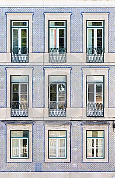 Facade of an ordinary house in Lisbon decorated with taditional ornamental azulejo tiles