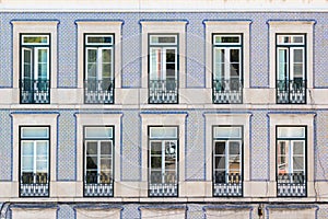 Facade of an ordinary house in Lisbon decorated with traditional ornamental azulejo tiles
