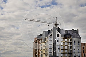 Facade part of modern residential apartment building against cloudy blue sky